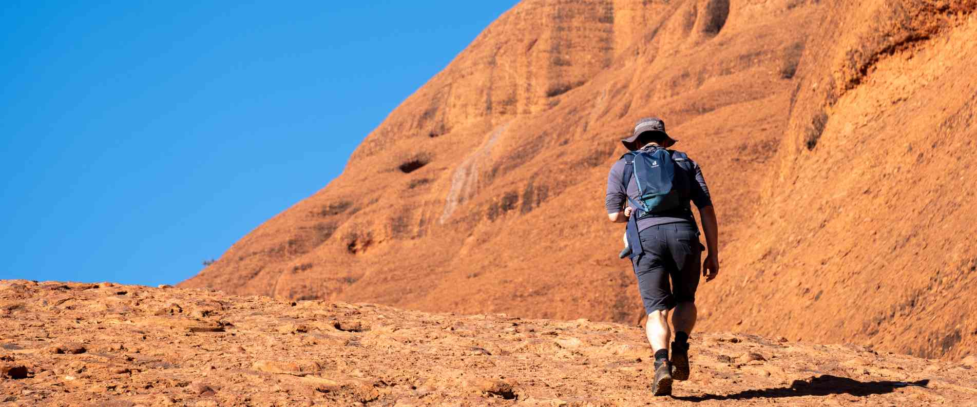 Man hiking up rock