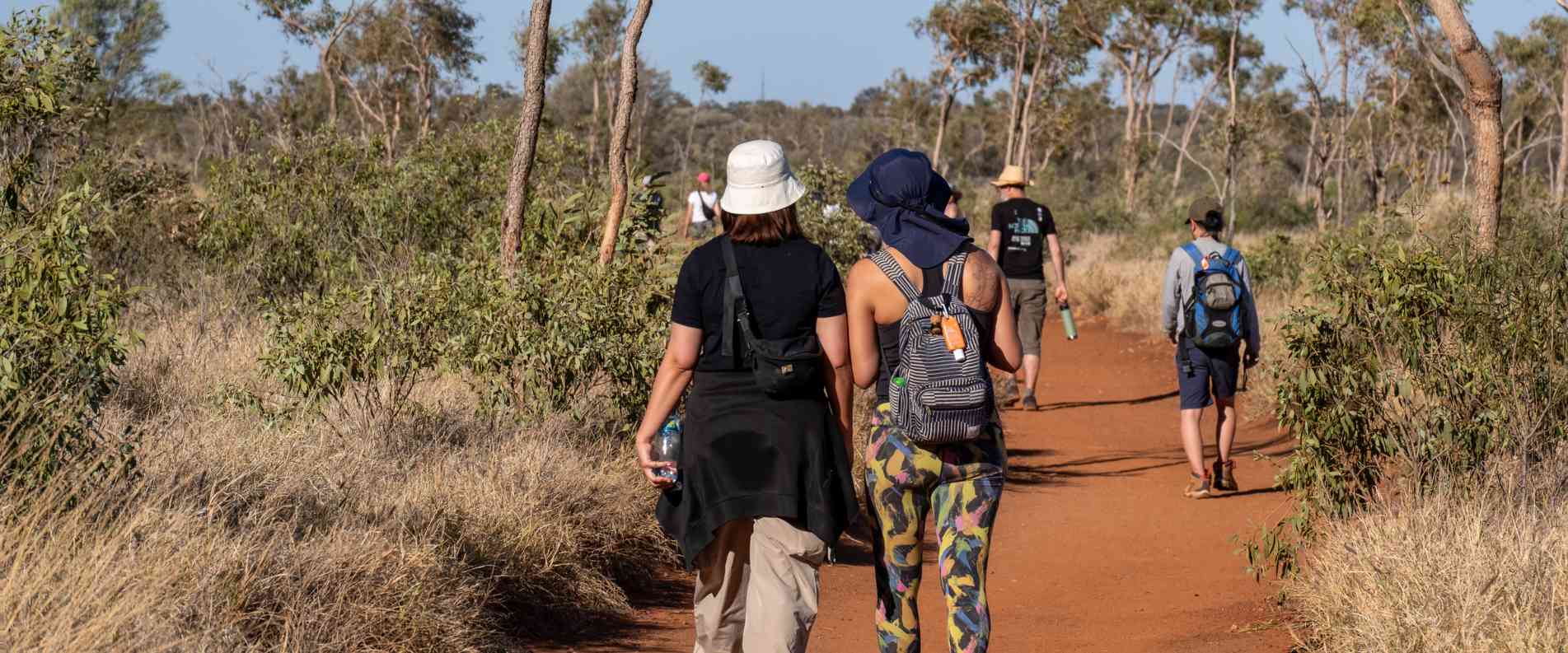 people walking around uluru