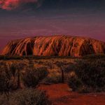 Uluru at dusk with dark skies